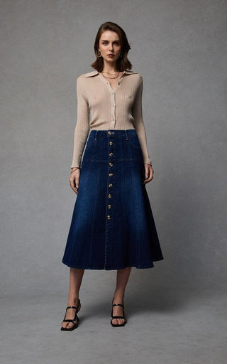 Women wearing a midi denim skirt with front button opening.