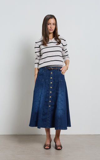 Women wearing a midi denim skirt with front button opening.