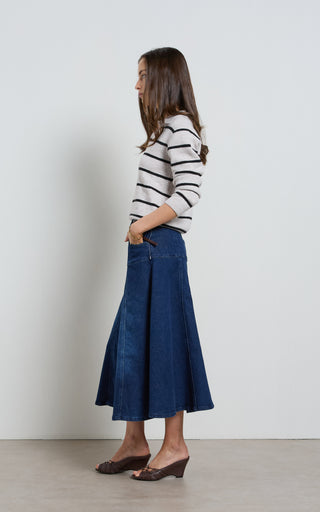 Women wearing a midi denim skirt with front button opening.
