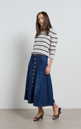 Women wearing a midi denim skirt with front button opening.