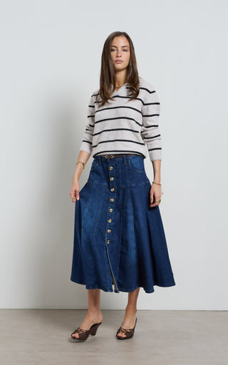 Women wearing a midi denim skirt with front button opening.
