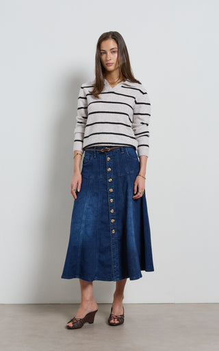 Women wearing a midi denim skirt with front button opening.