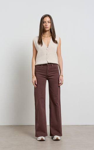 Women wearing a high waisted flare leg jeans in brown coloured denim