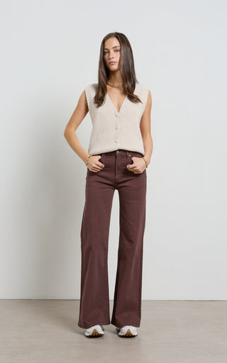 Women wearing a high waisted flare leg jeans in brown coloured denim