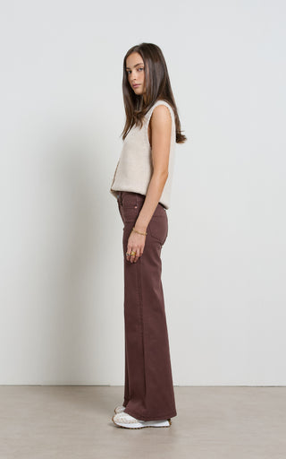 Women wearing a high waisted flare leg jeans in brown coloured denim