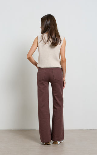 Women wearing a high waisted flare leg jeans in brown coloured denim
