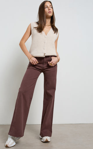 Women wearing a high waisted flare leg jeans in brown coloured denim