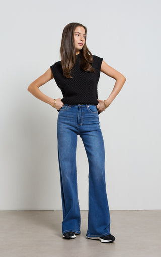 Women wearing a high waisted flare leg jeans in Pacific blue denim