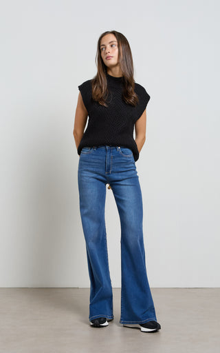 Women wearing a high waisted flare leg jeans in Pacific blue denim