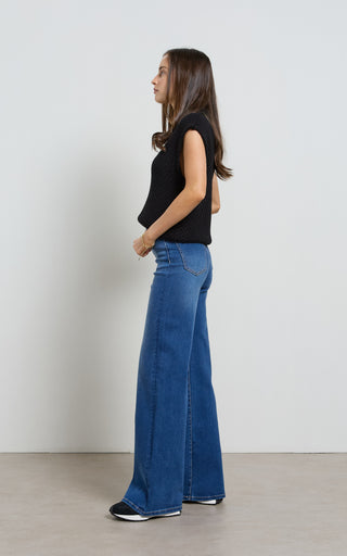 Women wearing a high waisted flare leg jeans in Pacific blue denim