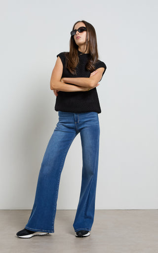 Women wearing a high waisted flare leg jeans in Pacific blue denim
