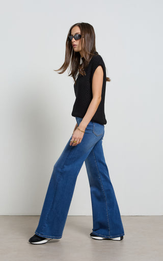 Women wearing a high waisted flare leg jeans in Pacific blue denim