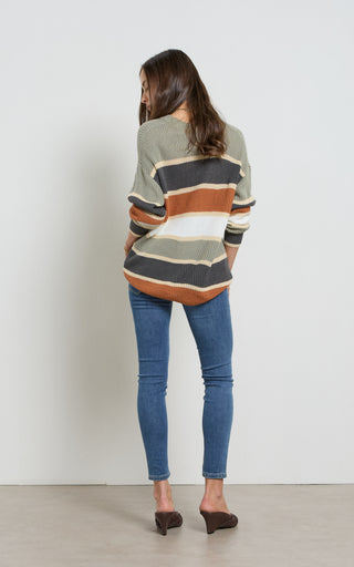 Woman wearing a Mid blue stretch denim skinny jeans standing against a white background