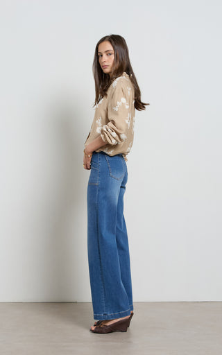 Women wearing straight leg wide jeans in indigo blue denim