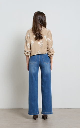 Women wearing straight leg wide jeans in indigo blue denim
